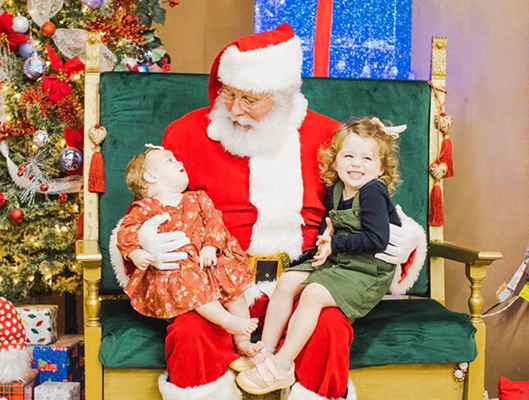 Santa With Two Small Guests On His Lap
