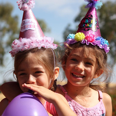 Two Girls With Party Hats On